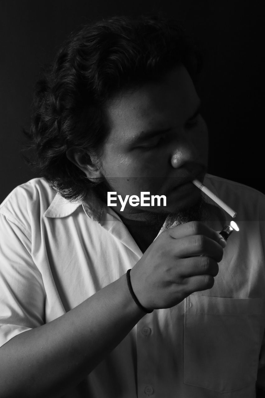 Young man smoking cigarette