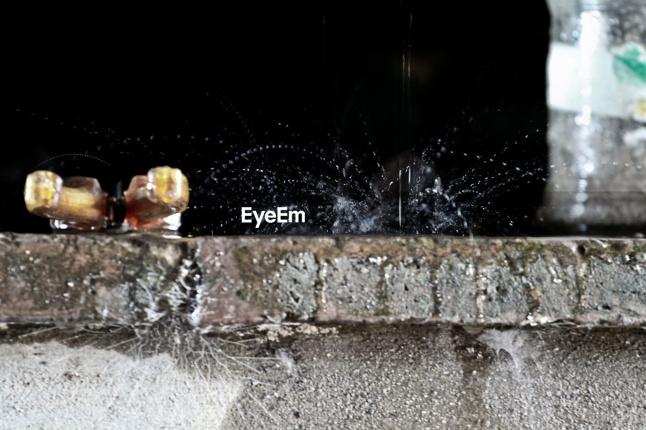 CLOSE-UP OF FOUNTAIN AGAINST BLURRED BACKGROUND