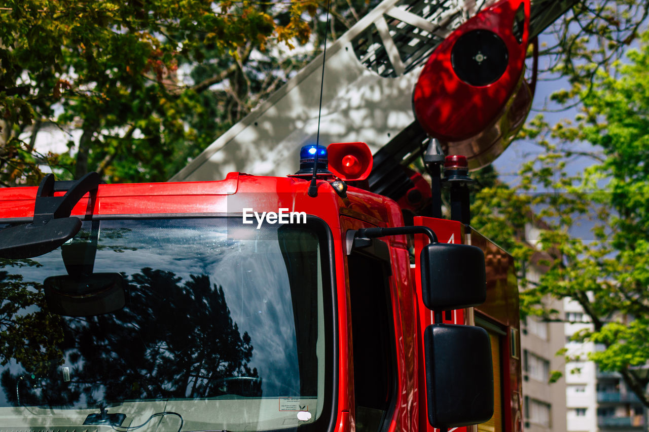 CLOSE-UP OF RED CAR AGAINST WATER