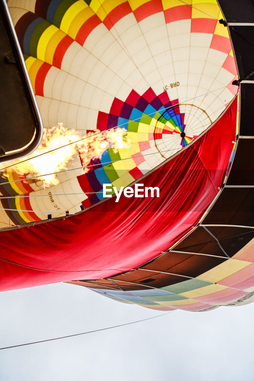 HIGH ANGLE VIEW OF MULTI COLORED HOT AIR BALLOON