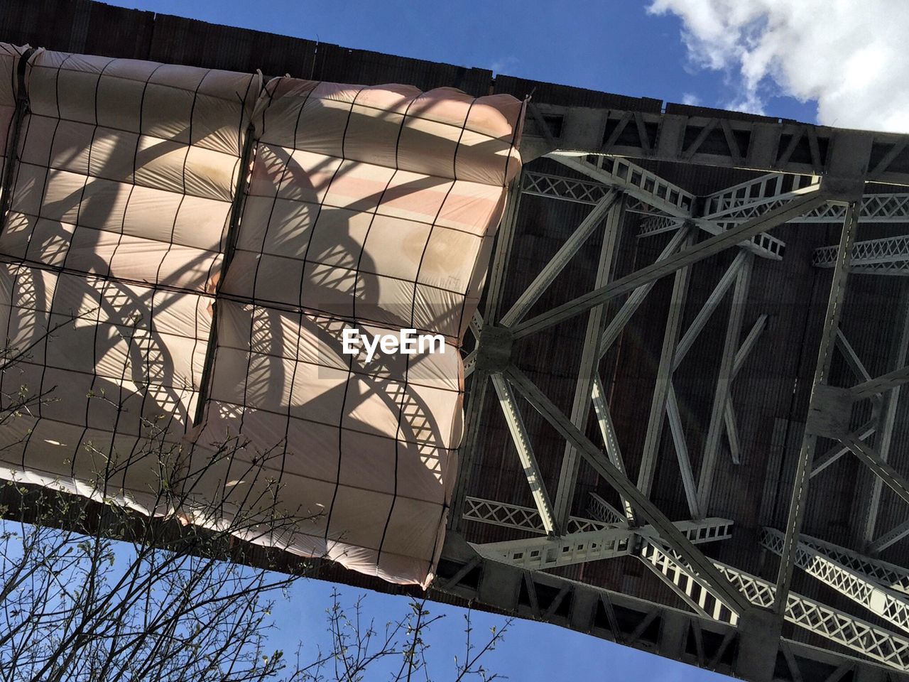 Directly below shot of aurora bridge against sky in city