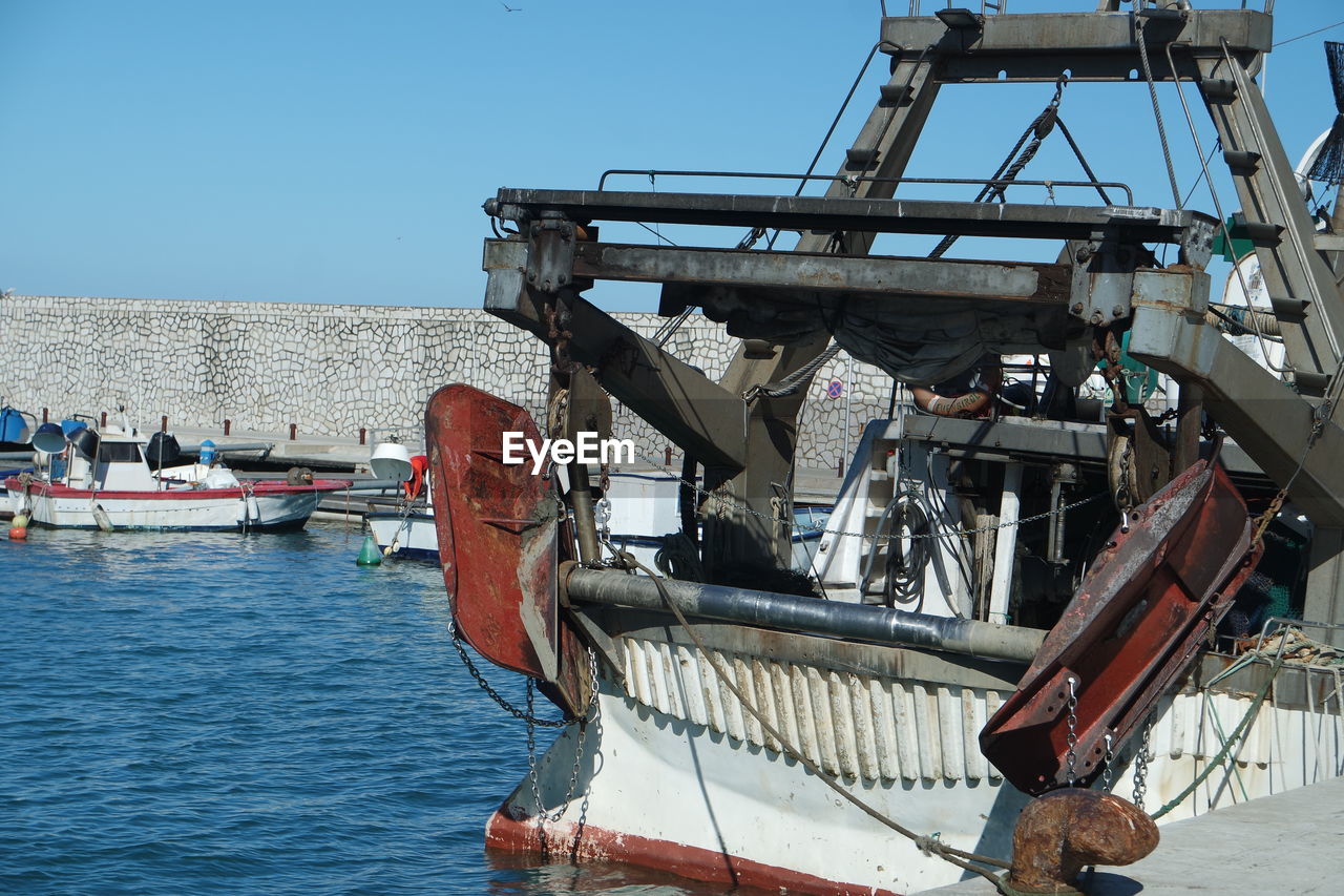 Ship at harbor against clear sky