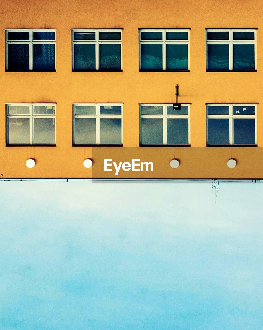 Upside down image of building against sky