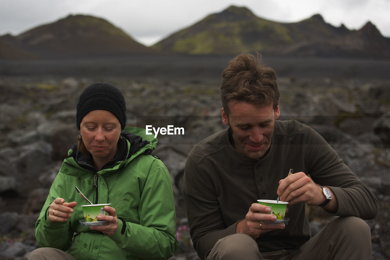 Couple eating icelandic skyr on a hiking break on laugavegur trek