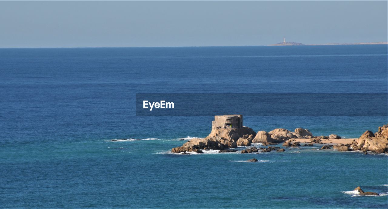 Scenic view of sea against blue sky