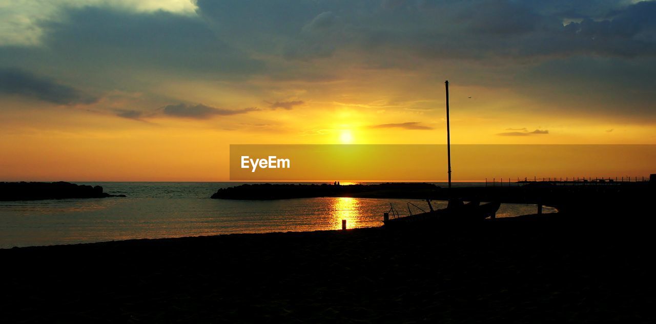 View of lake against sky during sunset