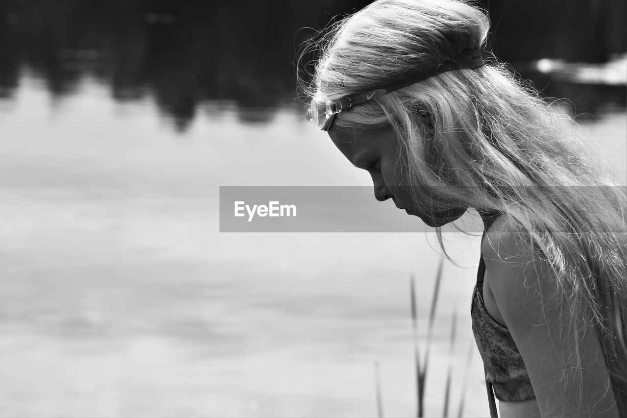 Close-up of girl against lake 