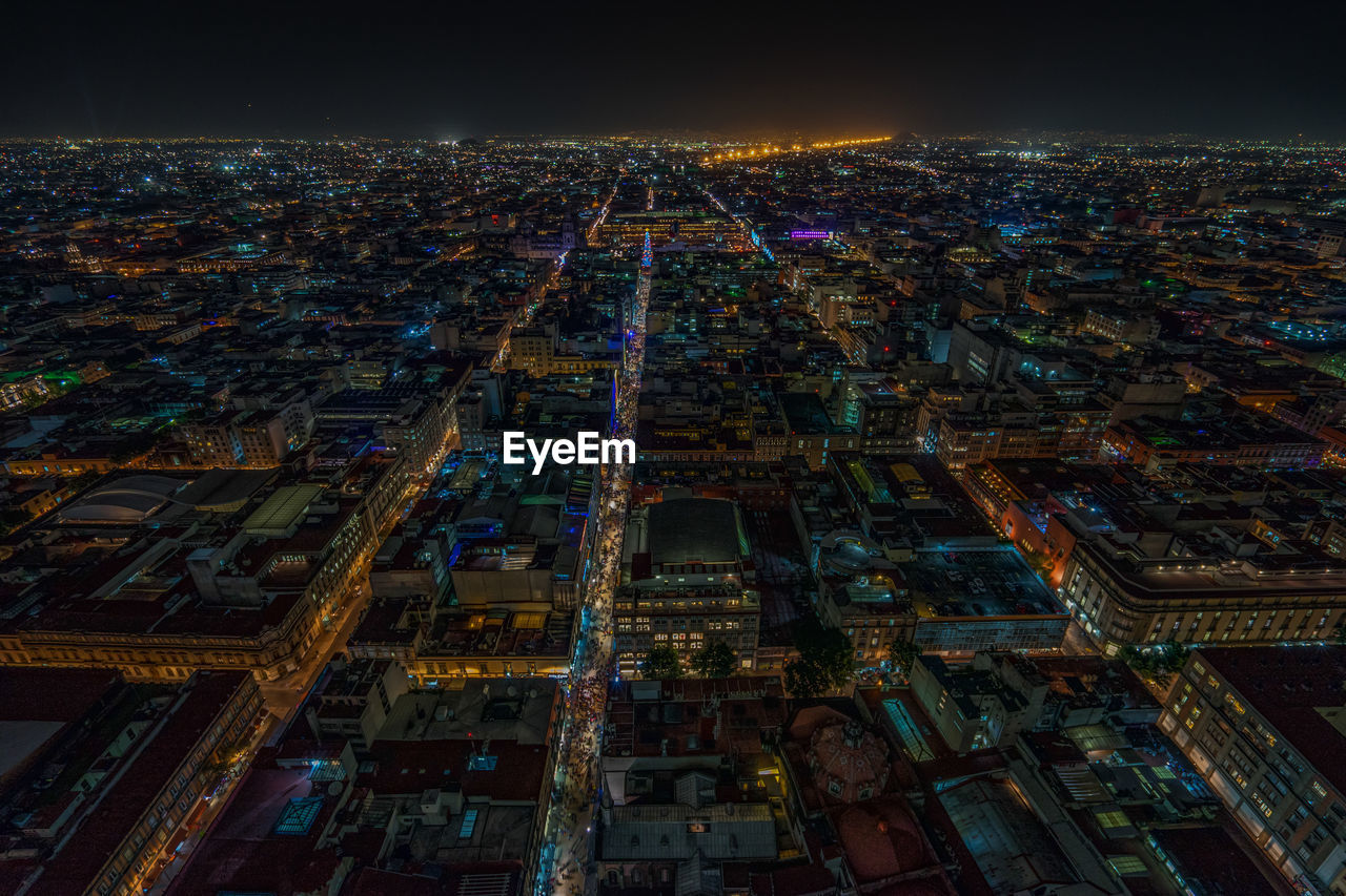 Illuminated cityscape against sky