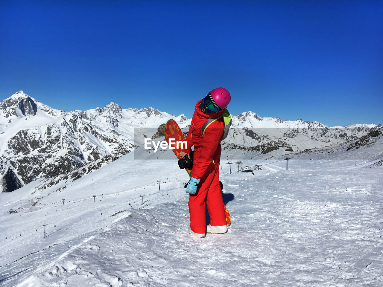 Full length of woman standing against snowcapped mountains