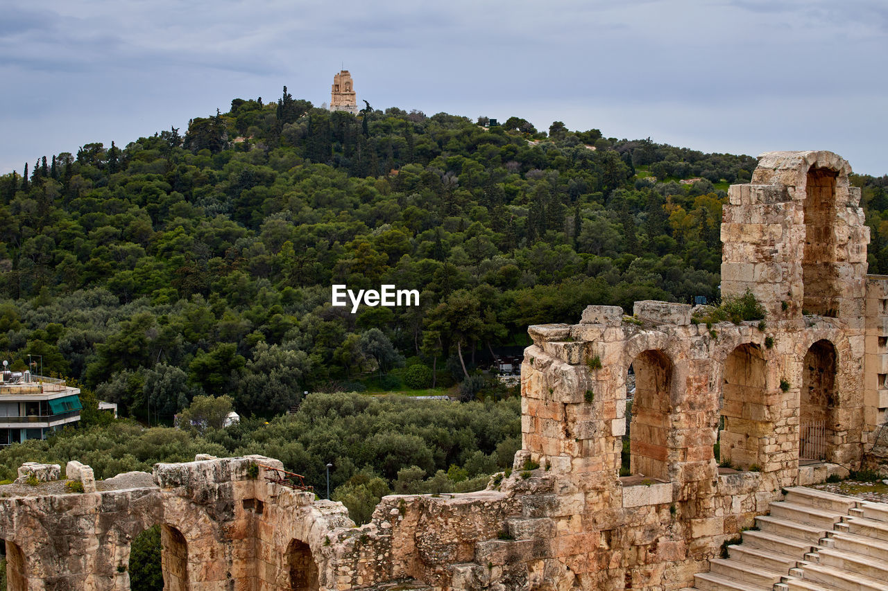 The odeon of herodes atticus, with philopappos monument in the background, athens, greece,