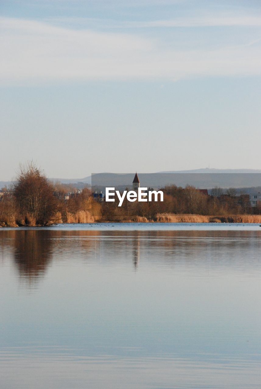 A view of a church across a lake, romantic dawn.