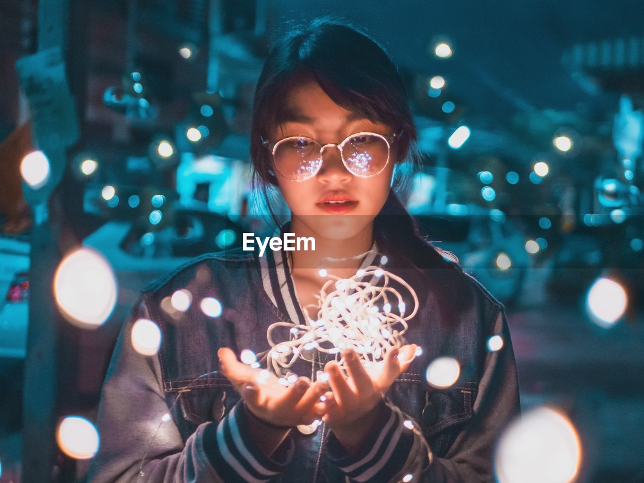 Woman looking at illuminated string light