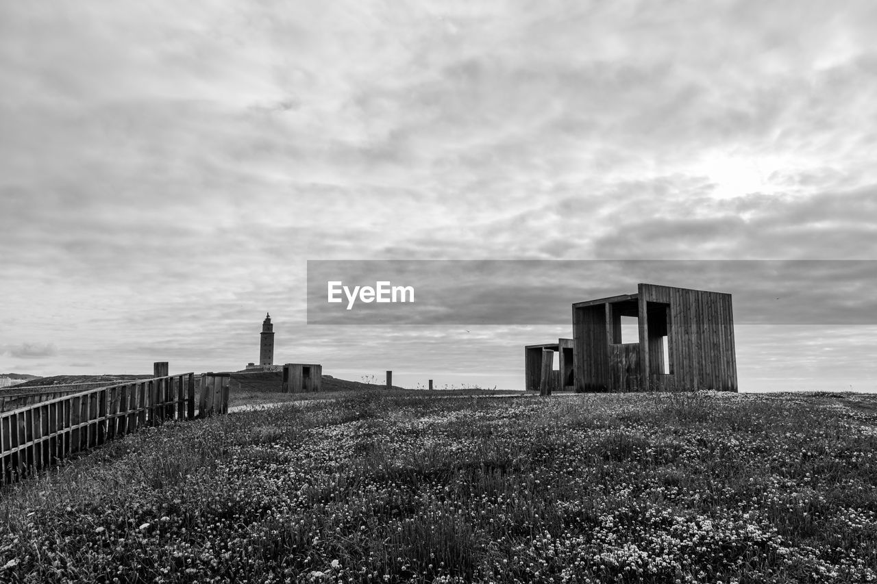 Abandoned built structure against cloudy sky