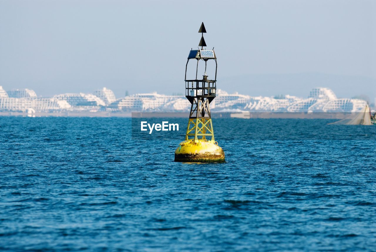 Buoy in sea against clear sky