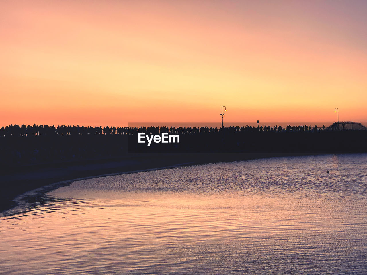 SCENIC VIEW OF LAKE AGAINST SKY AT SUNSET