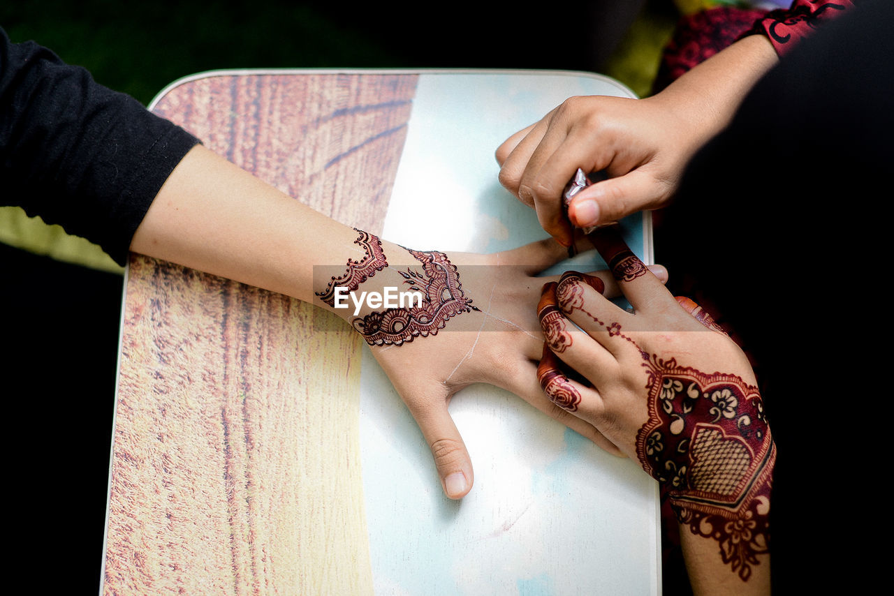 Close-up of henna hands