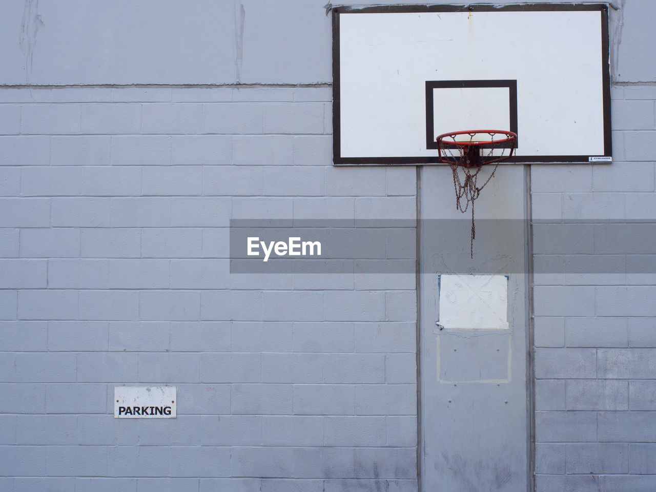 Basketball hoop against brick wall