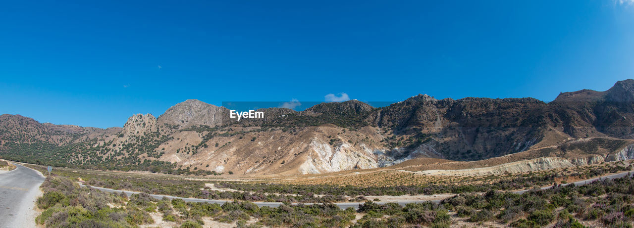 PANORAMIC VIEW OF MOUNTAINS AGAINST BLUE SKY