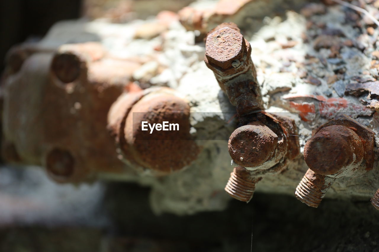 Close-up of rusty, sandy, engine parts.