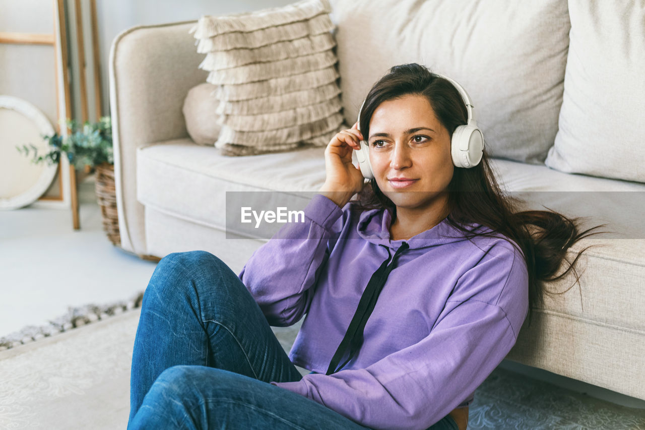 The girl leaned her back on the sofa and prepared for meditation