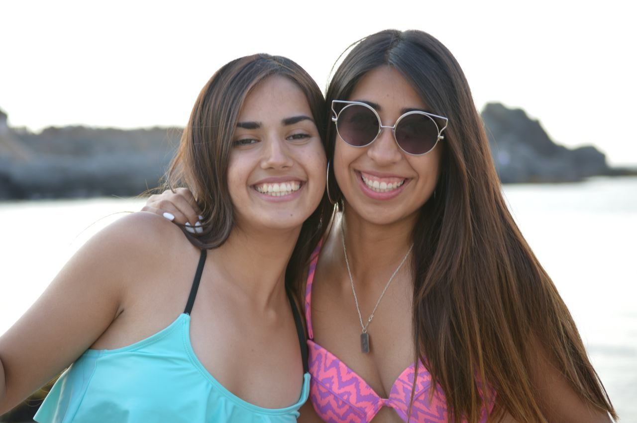 Portrait of smiling friends at beach