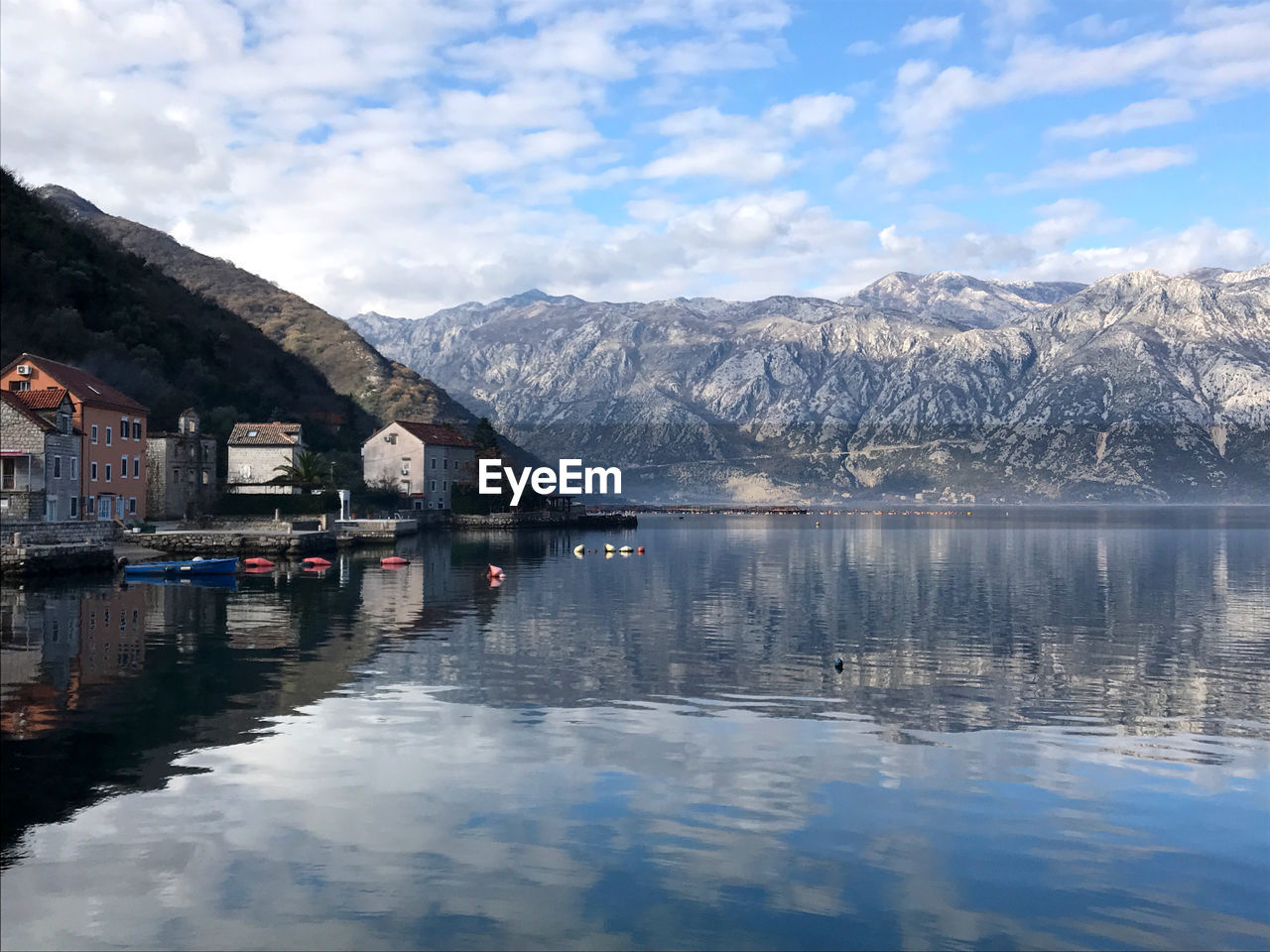 Scenic view of lake and mountains against sky