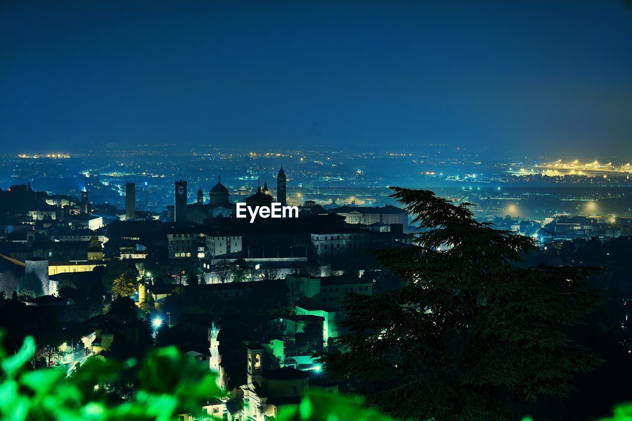 High angle view of illuminated buildings in city at night