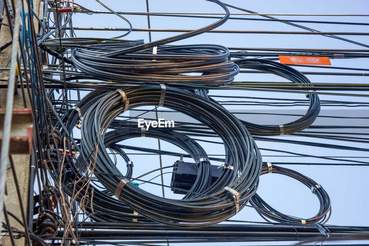 Low angle view of cables against sky