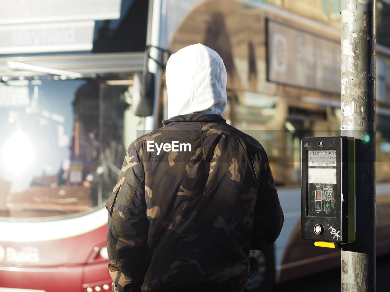 Rear view of man standing at bus