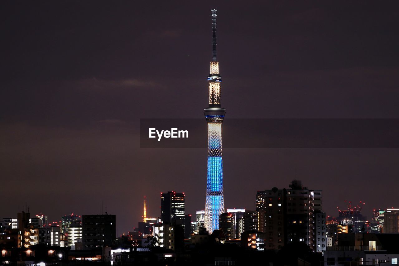 Illuminated tower in city at night