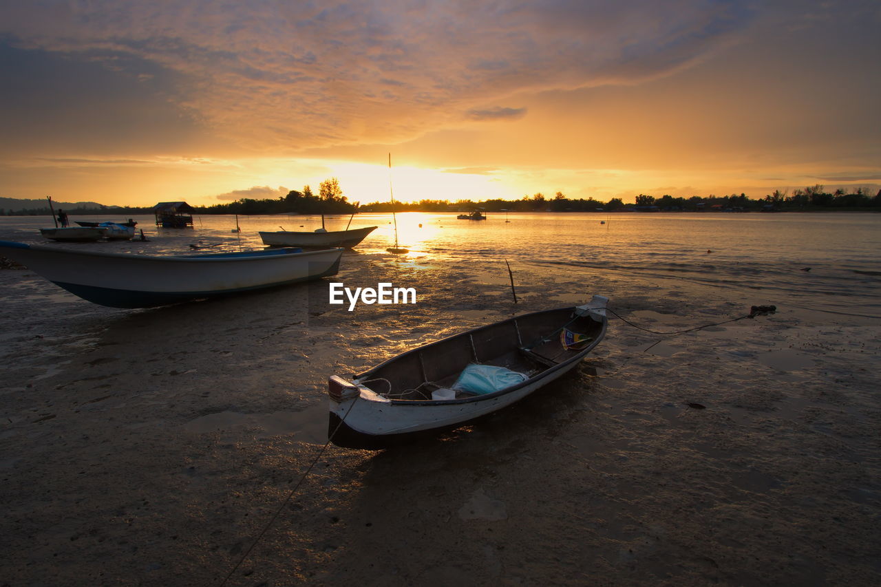 Boat in sea at sunset