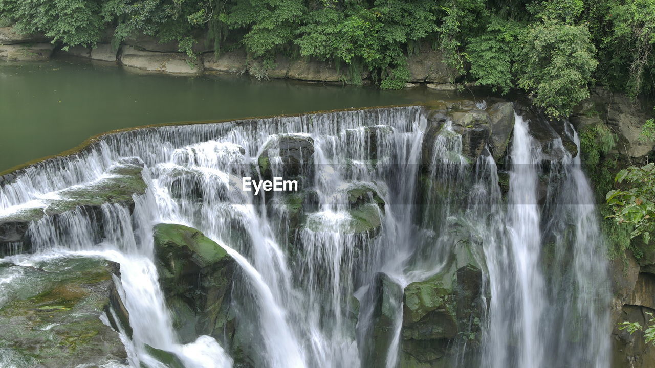 VIEW OF WATERFALL IN FOREST