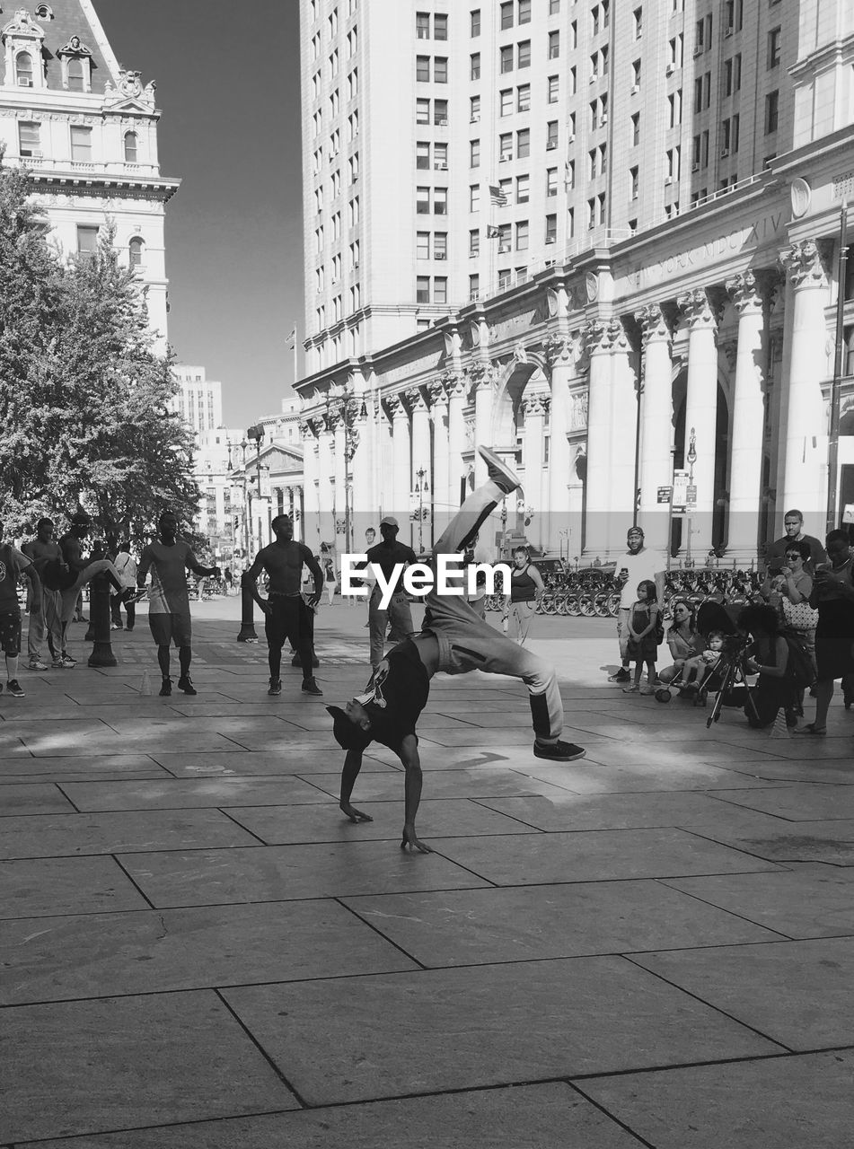 GROUP OF PEOPLE WALKING ON STREET