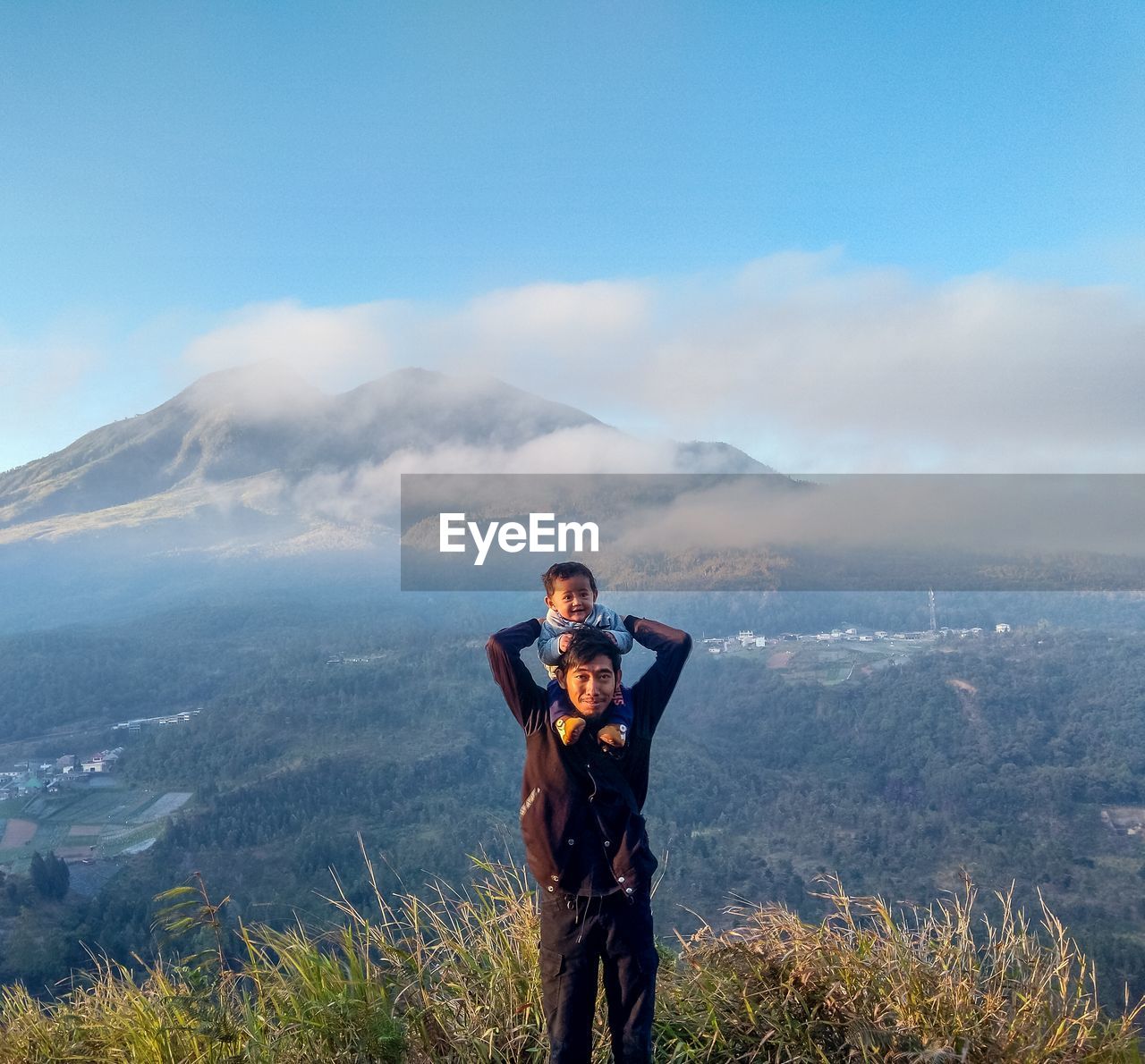 Full length of man standing on mountain against sky