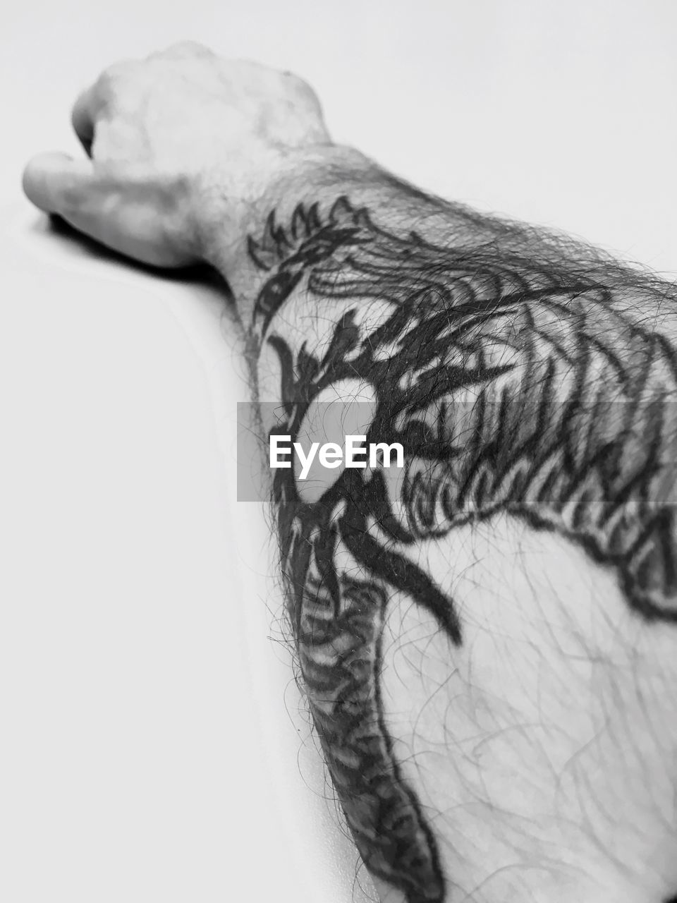 Cropped image of man with tattooed hand of over white background