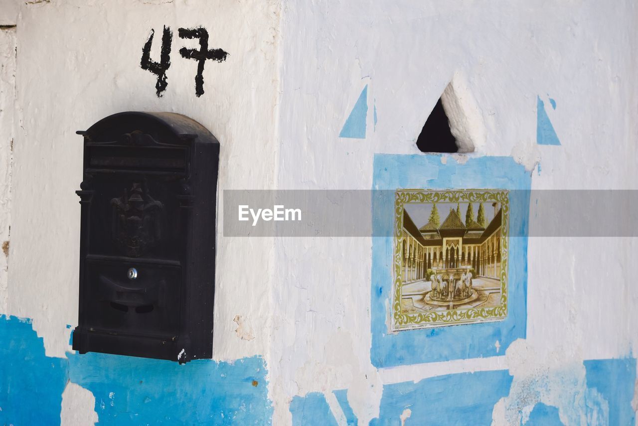 Old-fashioned mailbox on wall of building