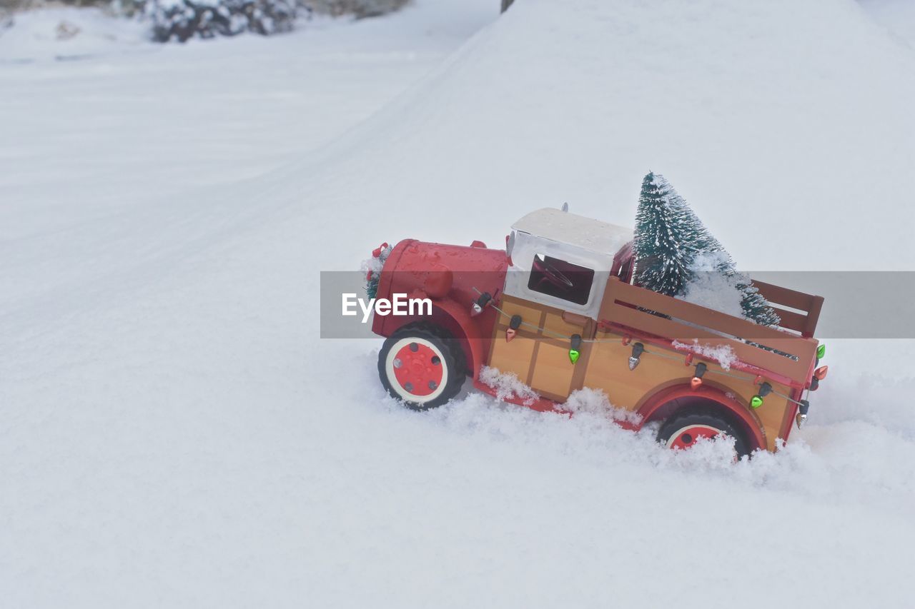 CAR ON SNOW COVERED ROAD DURING WINTER