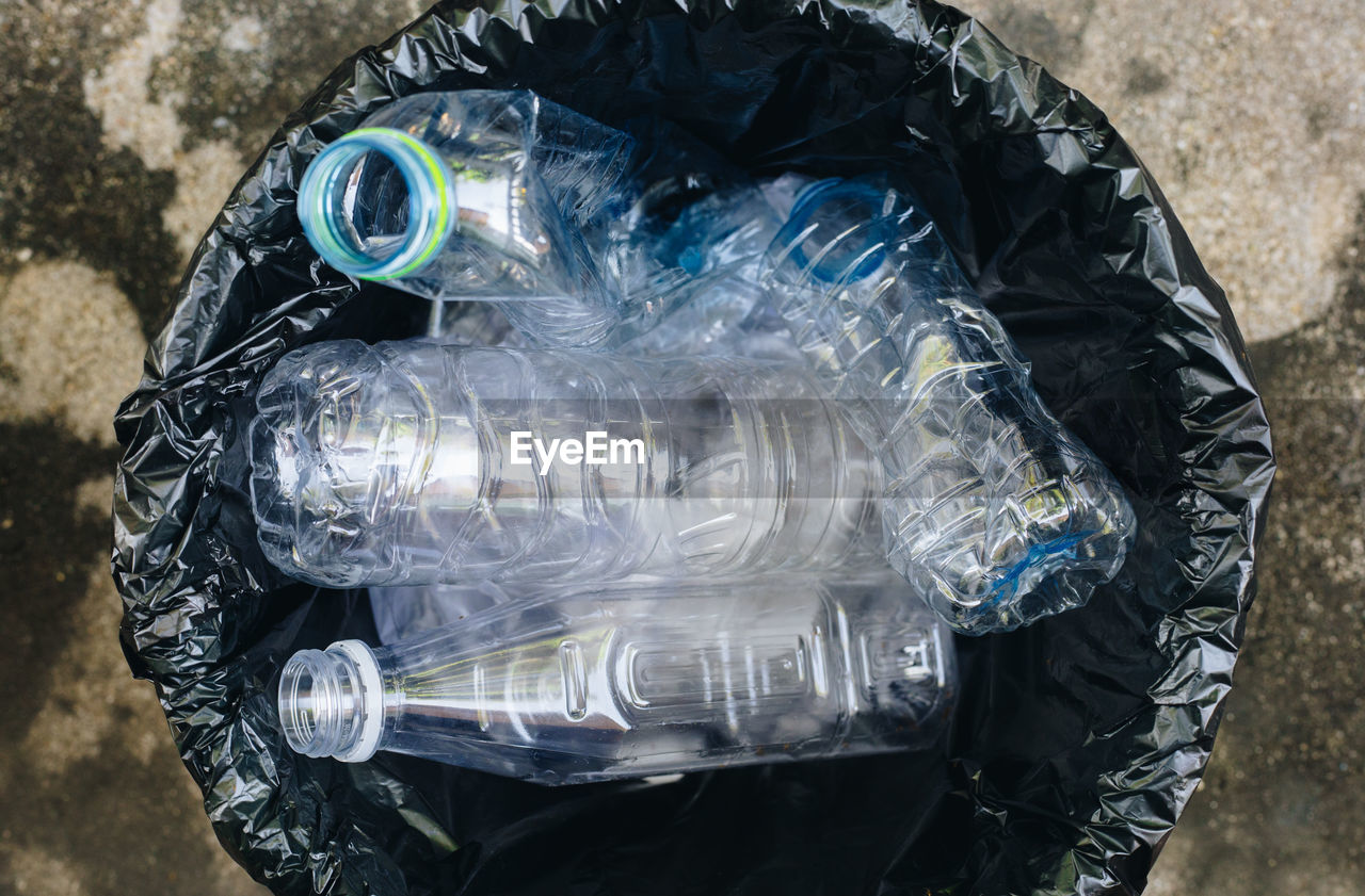 Directly above shot of plastic bottles in garbage bin