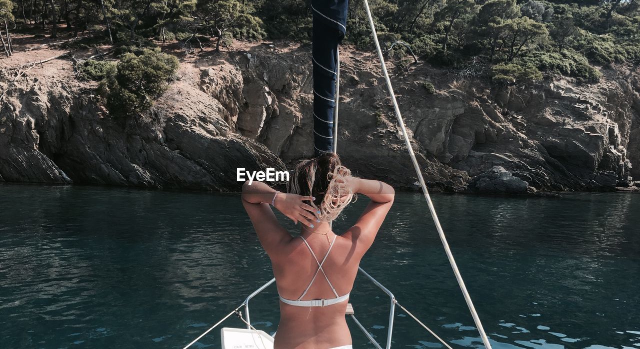 Rear view of woman in boat on sea