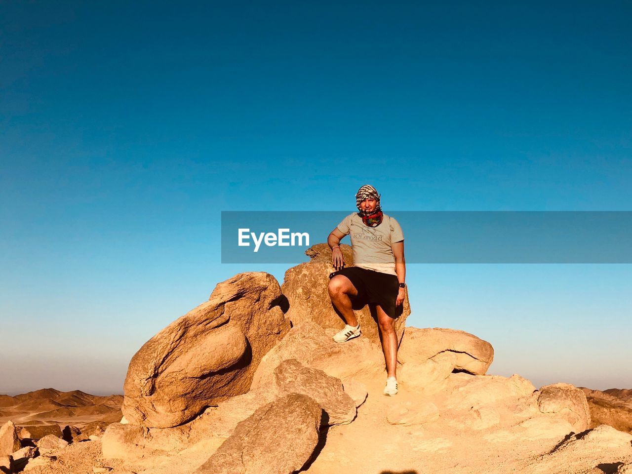 LOW ANGLE VIEW OF PERSON ROCK AGAINST BLUE SKY