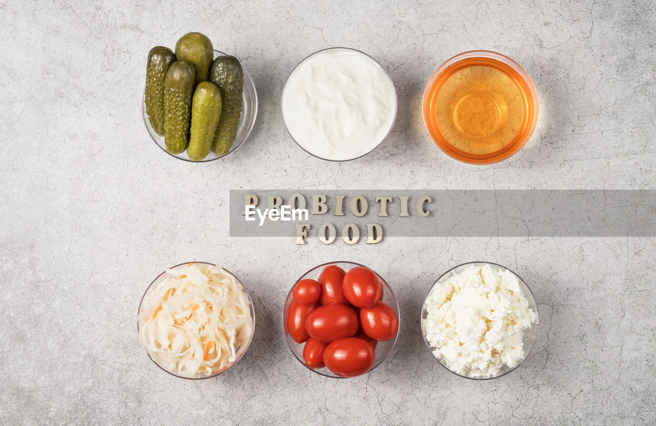 food and drink, food, healthy eating, freshness, fruit, text, produce, studio shot, no people, wellbeing, indoors, still life, western script, directly above, vegetable, gray, tomato, high angle view, communication, variation, gray background