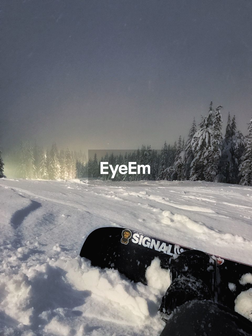 SNOW ON CAR AGAINST SKY AT NIGHT