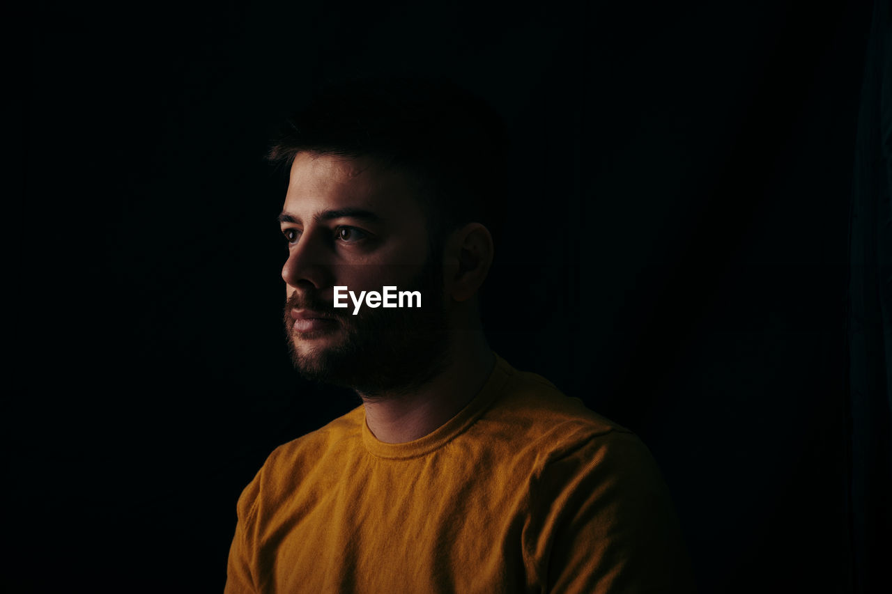 Portrait of young man looking away