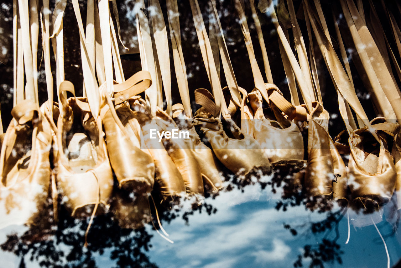 Low angle view of ballet shoes seen through glass window