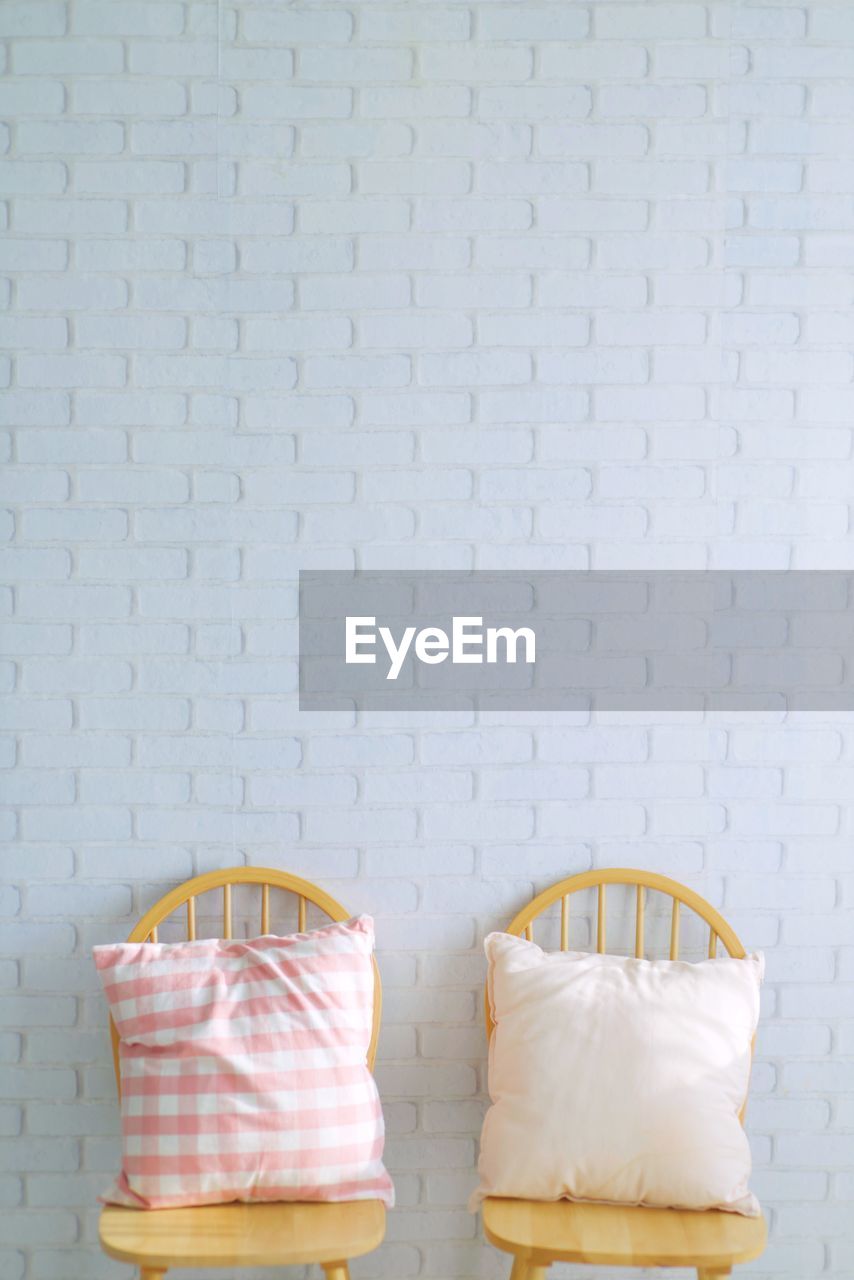 Close-up of basket on table against wall