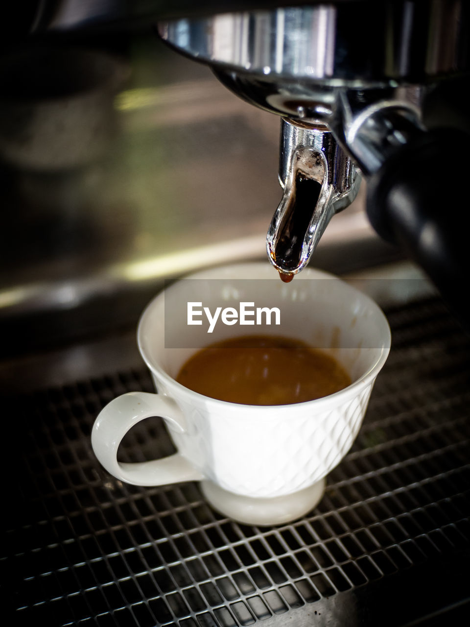 Close-up of coffee cup on machine