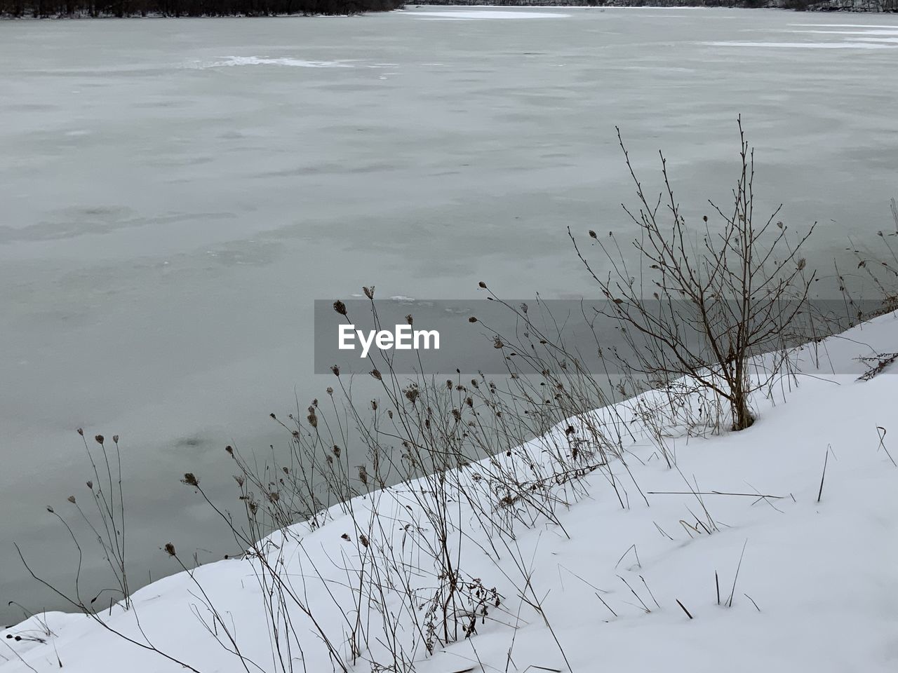 HIGH ANGLE VIEW OF FROZEN LAKE