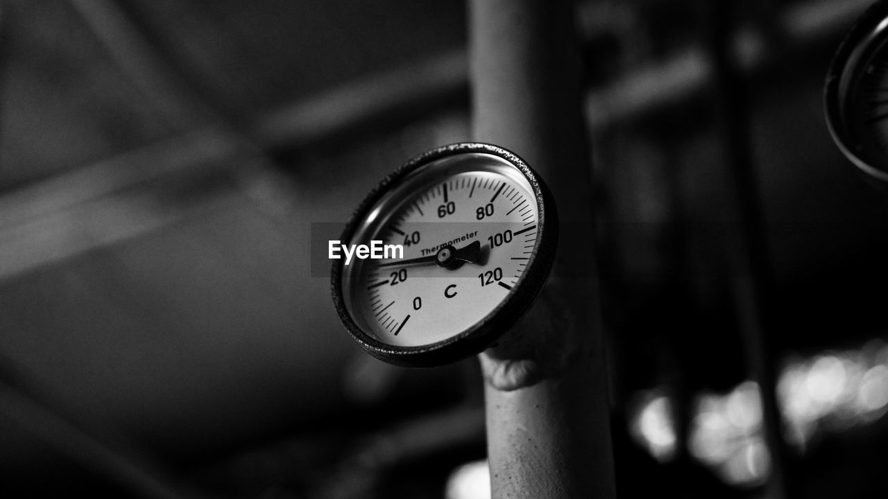 Low angle view of temperature gauge on machinery