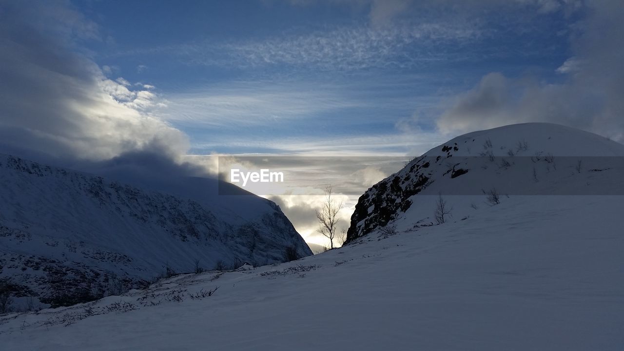 Scenic view of snow mountains against sky