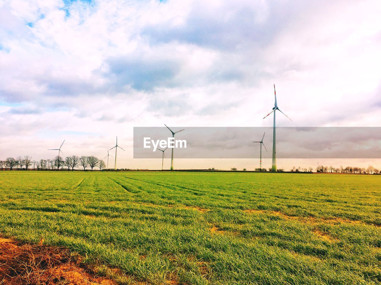 Group of windmills producing green energy in a field near diest belgium